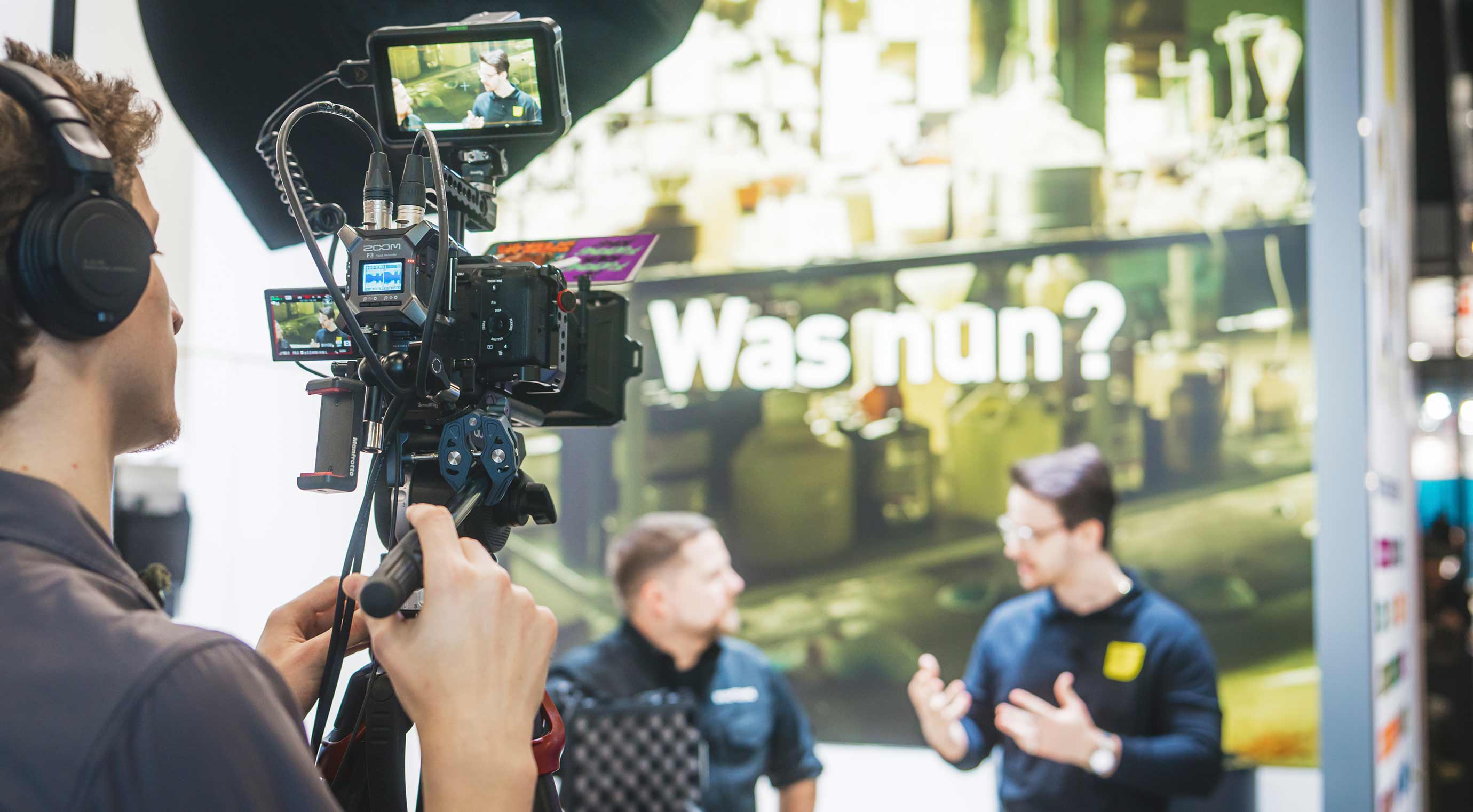 Video camera filming a product presentation at an exhibitor stand