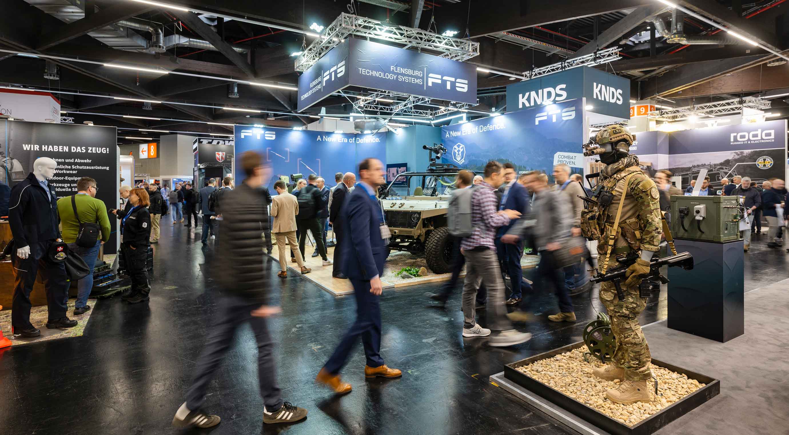 Visitors in the Enforce Tac exhibition hall. Exhibitors’ stands are visible in the background.