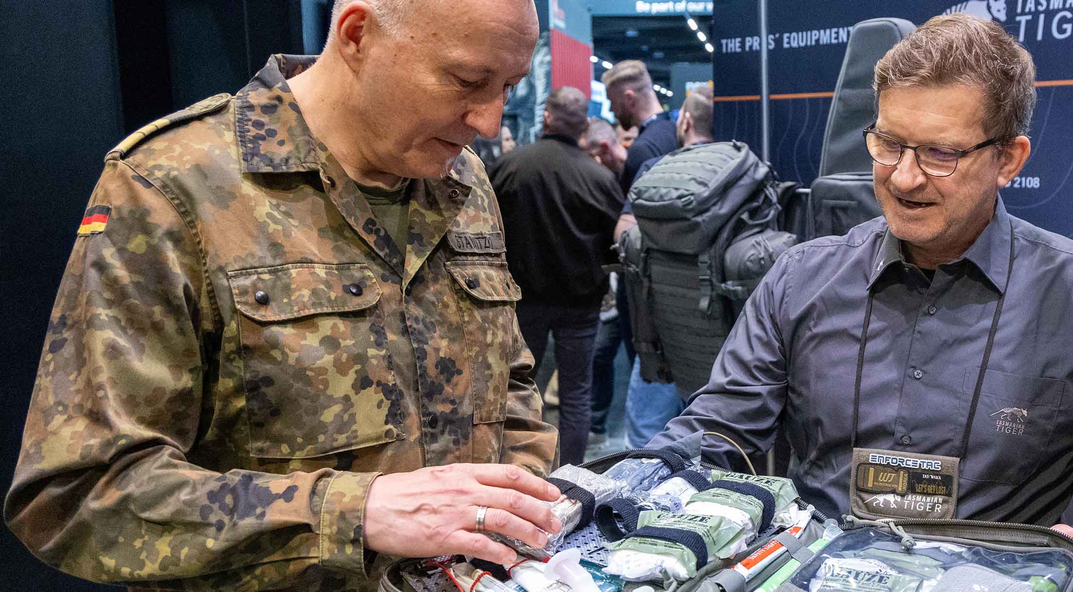 Vice Admiral Carsten Stawitzki looks at a product at an exhibitor's stand at Enforce Tac