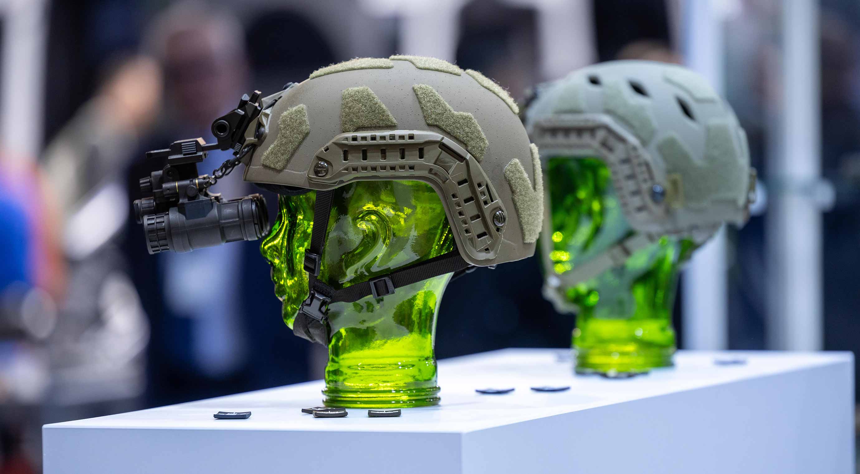 Close-up of two helmets with optics as a product on display at Enforce Tac